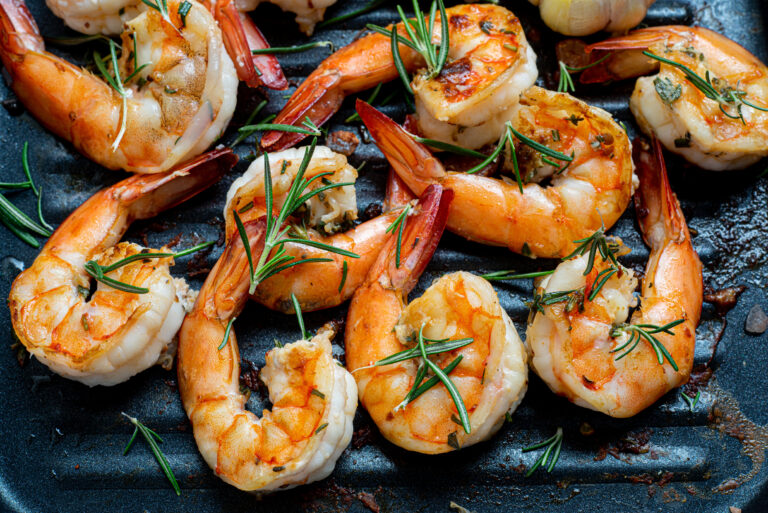 Stock image of Grilled tiger shrimps with spice and lemon.